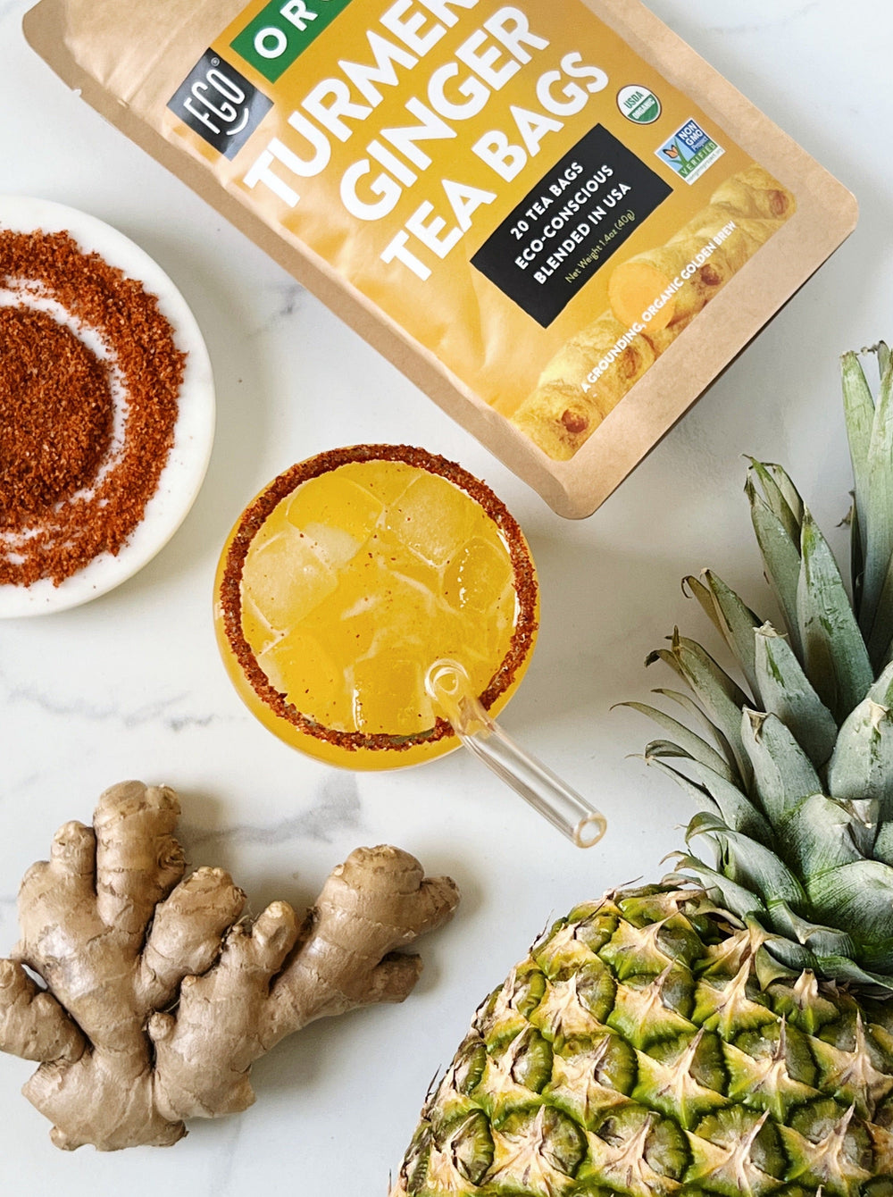 A glass of iced pineapple turmeric ginger tea.