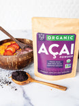 Freeze-dried acai powder in a wooden spoon.
