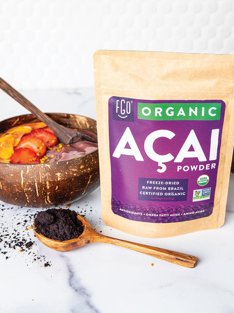Freeze-dried acai powder in a wooden spoon.