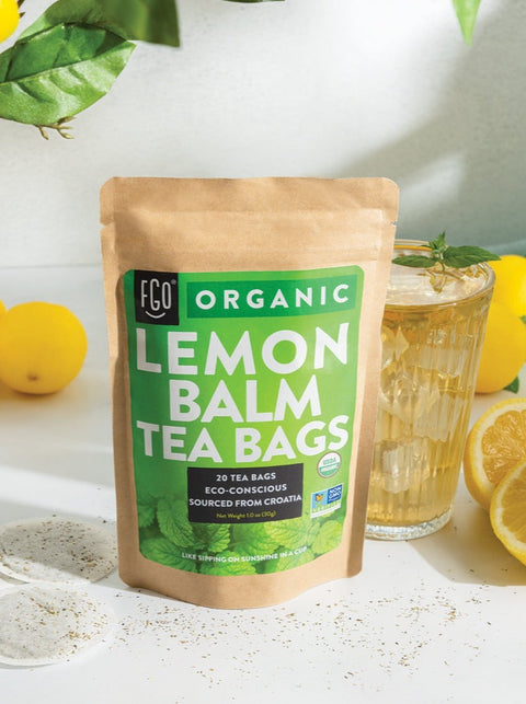 Eco-conscious lemon balm tea bags and a glass of iced tea.