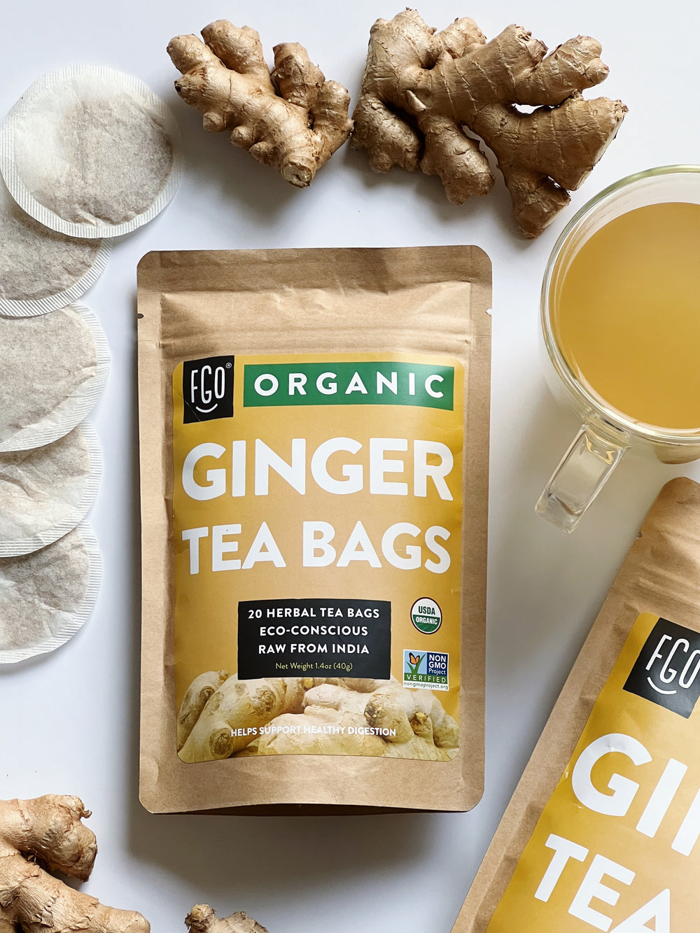 Fresh ginger root and hot ginger tea in a mug.