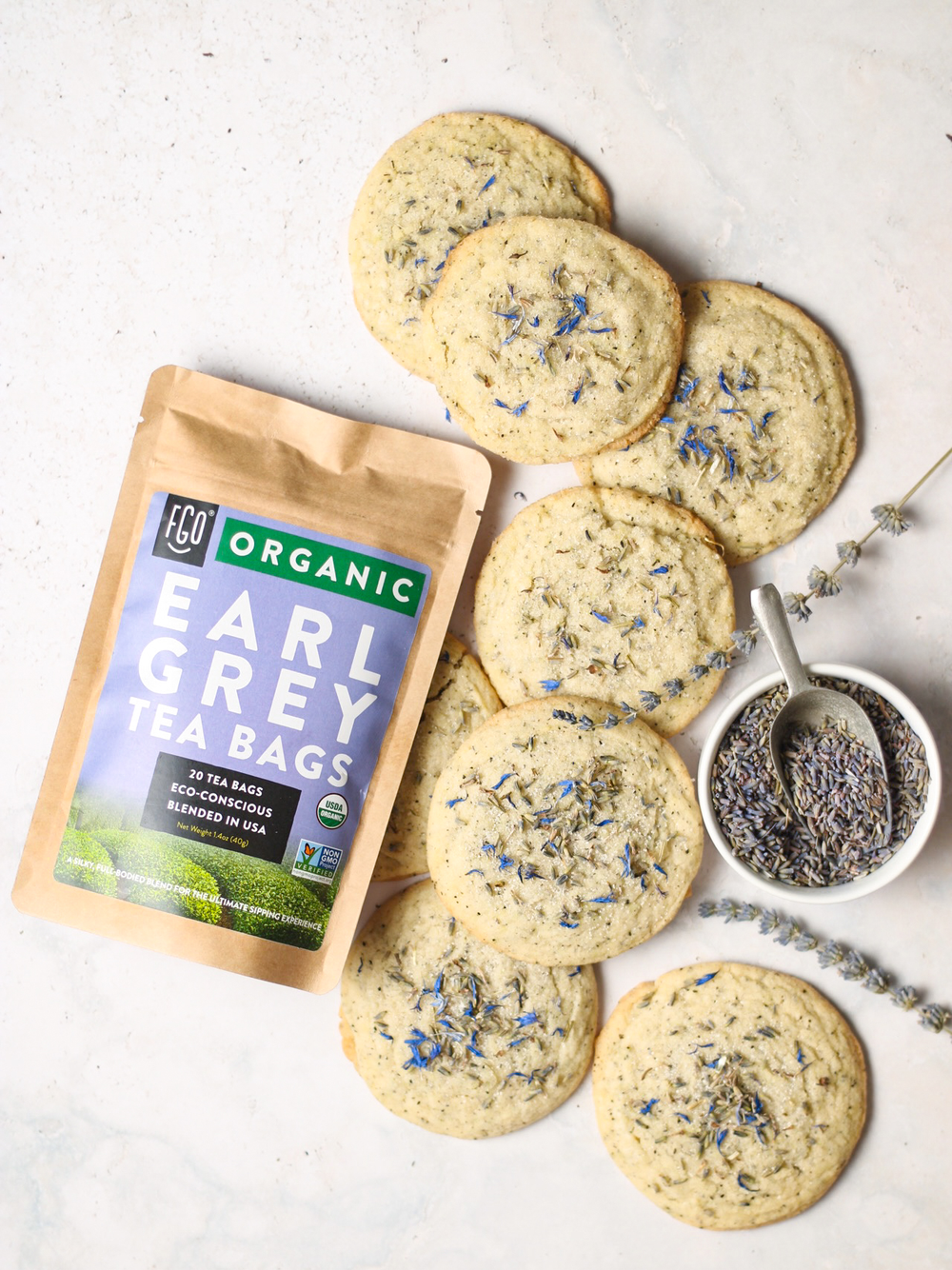A half dozen earl grey lavender cookies sprinkled with dry lavender flowers.