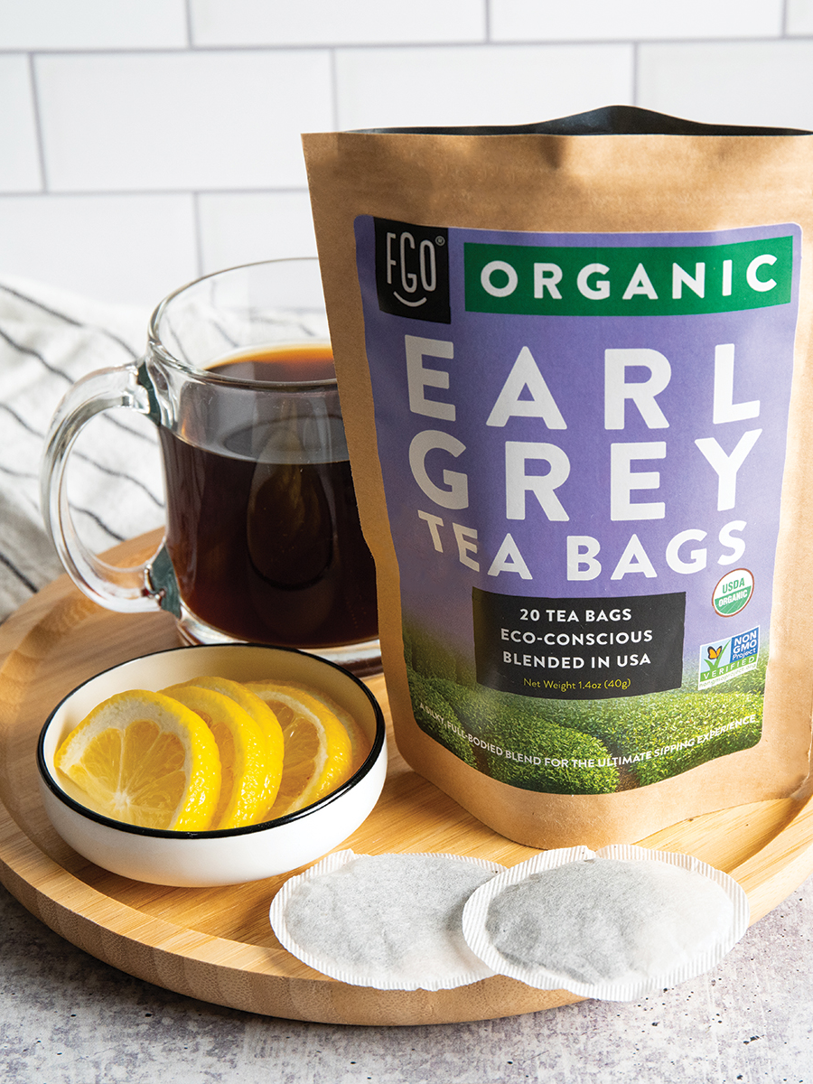 A pitcher of hot earl grey tea with lemon slices.