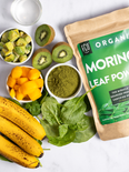 A kraft pouch of moringa leaf powder and raw ingredients for a green smoothie.