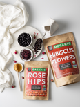 Raw ingredients for hibiscus rose hips boba latte: rose hips, hibiscus flowers, sweet honey, and black pearl tapioca.