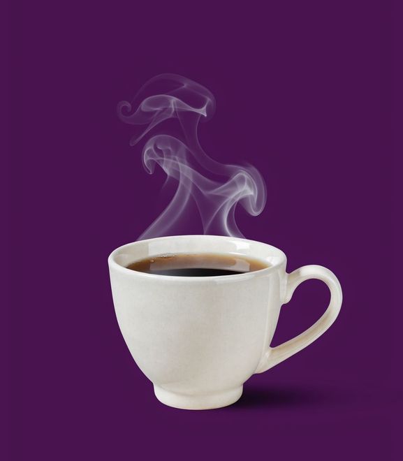A white cup of steaming dark tea on a deep purple ground
