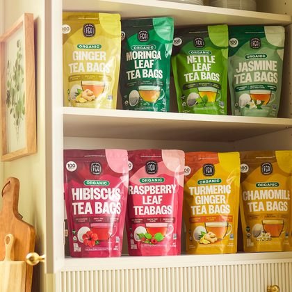 A kitchen cupboard shelf stocked with FGO tea pouches