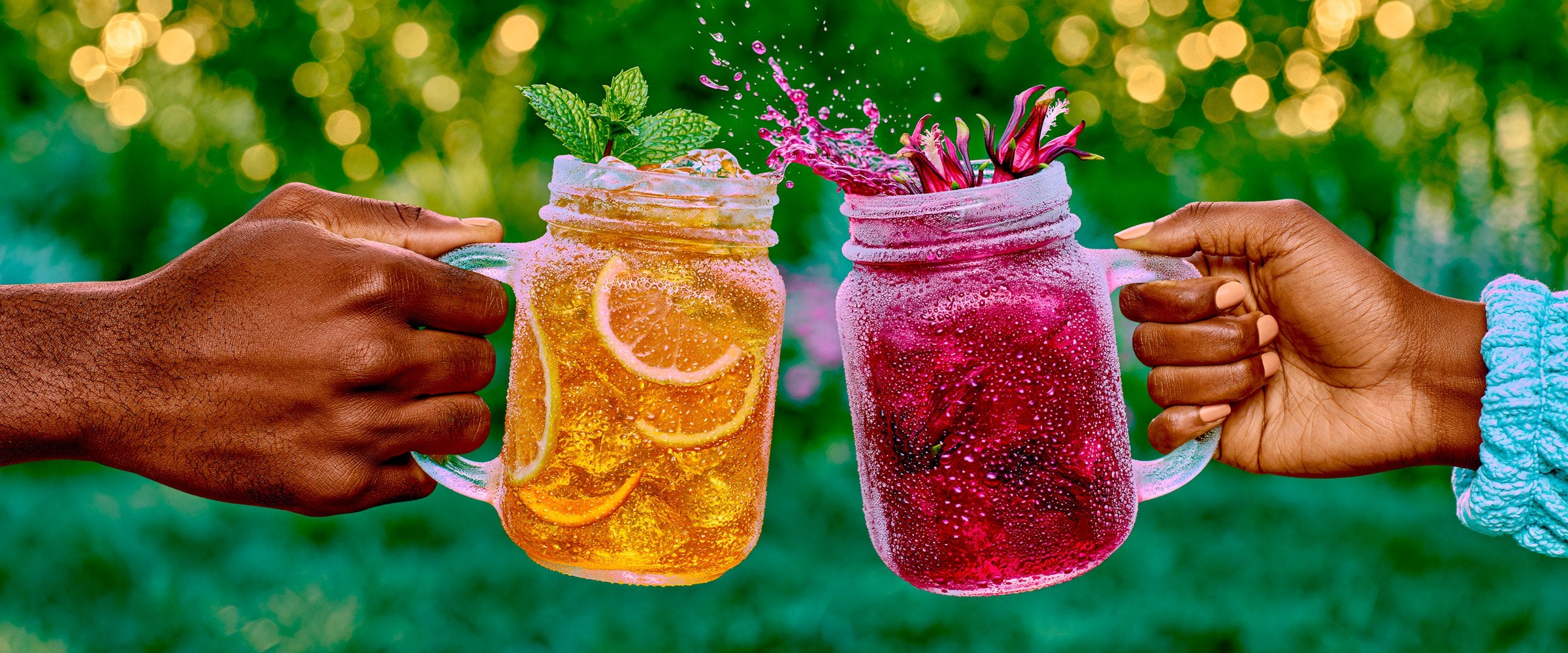 Two people toasting tall mason jars of iced hibiscus and lemon tea outdoors